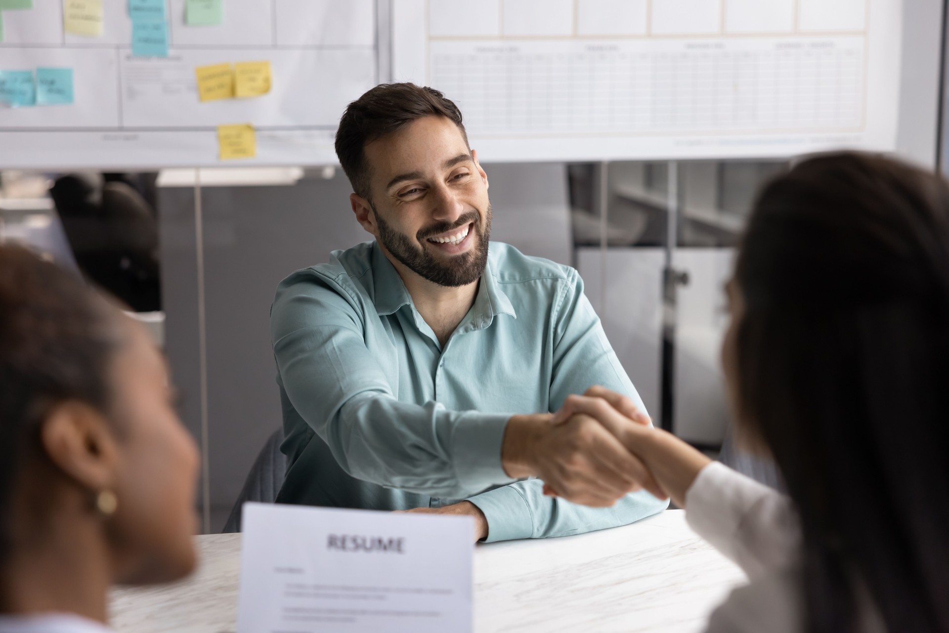Man shaking hands with female HR manager